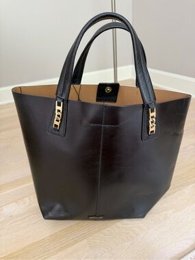 BCBGMaxAzria Black Leather Tote with Gold Hardware and two small wallet inside